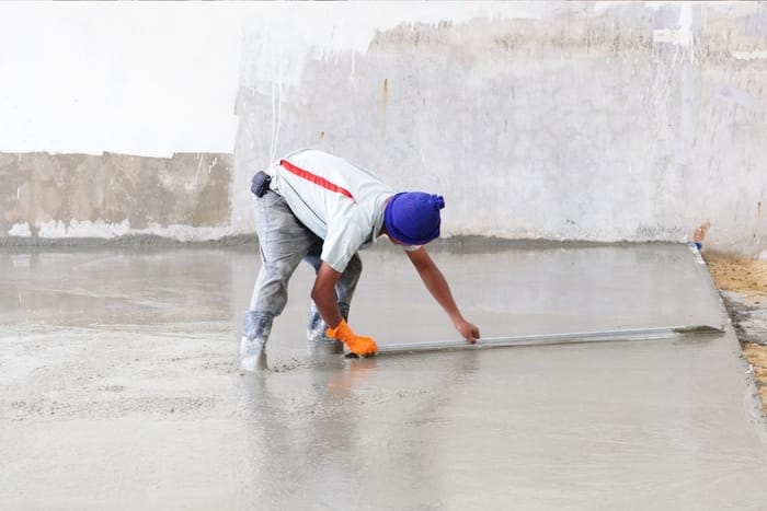 employee smoothing concrete floor using a broom at mackay concreters